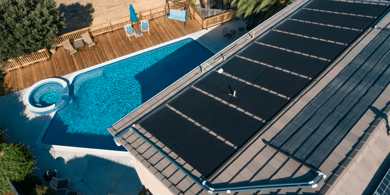 instalación de paneles solares en el tejado de una casa para calentar la piscina